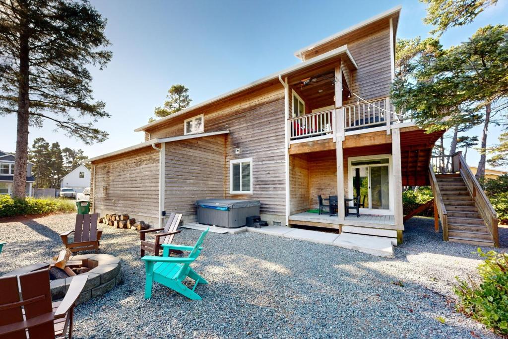 a home with a patio and a house at The Ocean Dream in Rockaway Beach
