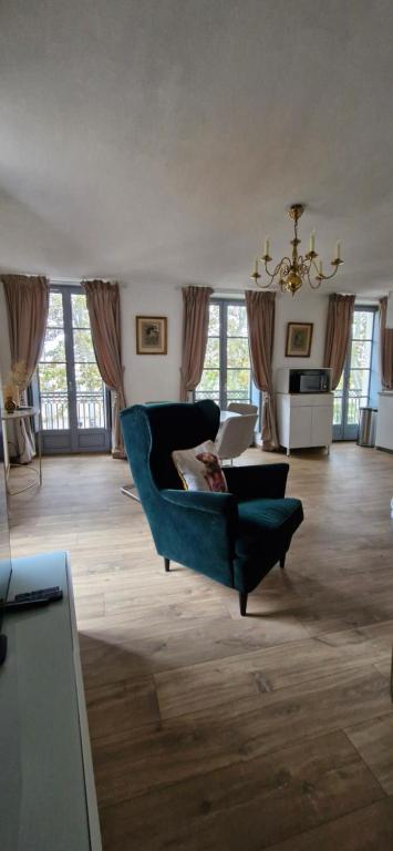 - un salon avec un fauteuil bleu et un canapé dans l'établissement Via Narbona, à Narbonne