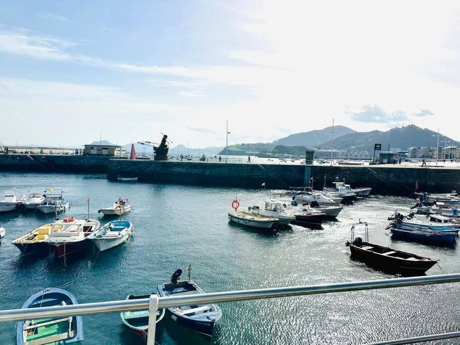 a group of boats docked in a harbor at Luminoso piso con vistas al Puerto in Castro-Urdiales