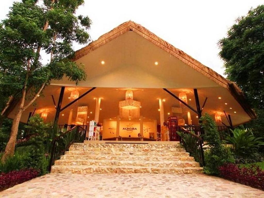 a building with stairs in front of it at Aurora Resort Kanchanaburi in Kanchanaburi