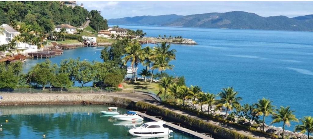 a group of boats docked in a body of water at Apto resort de Angra in Mangaratiba