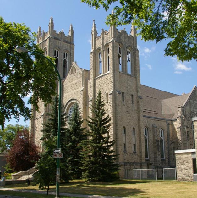 a large brick building with a tower on top of it at Merj's Guest House in Wolesly in Winnipeg