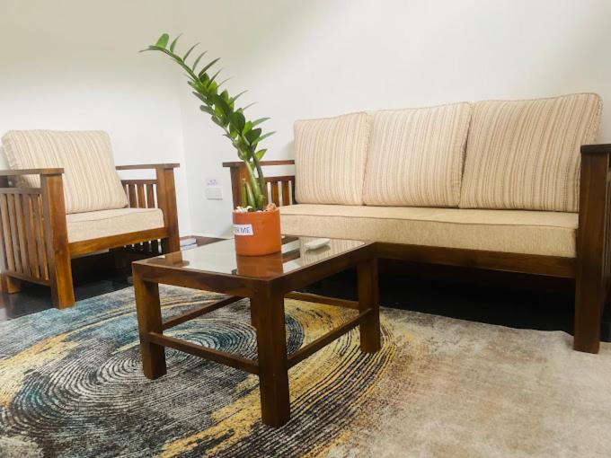 a living room with a couch and a coffee table at The Motel Express - Colombo Border in Wattala