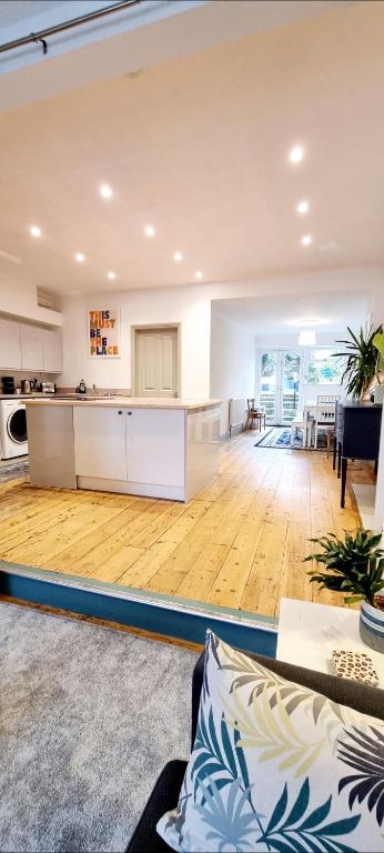 an open kitchen and living room with wooden floors at Time & Tide Town House in Seaford