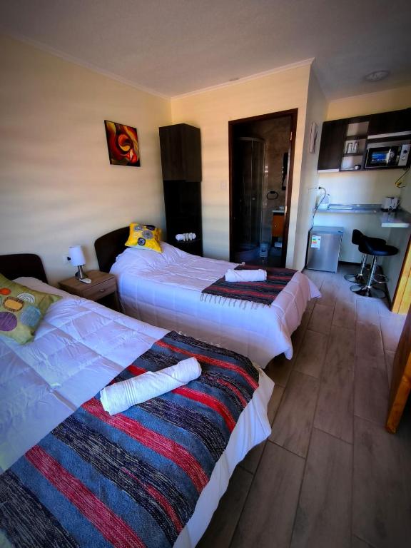 Postel nebo postele na pokoji v ubytování APART HOTEL EN BULNES