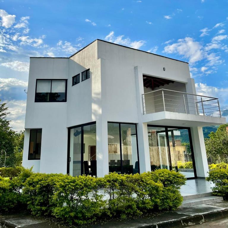 a white house with a balcony on it at Casa Lili in Sopetrán