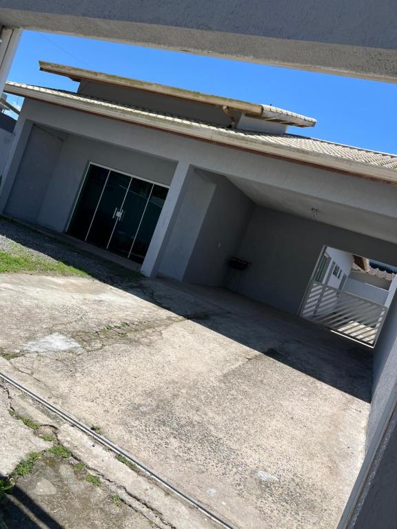 a building with a window and a stairway in it at Casa grande pé na areia Peruibe in Peruíbe