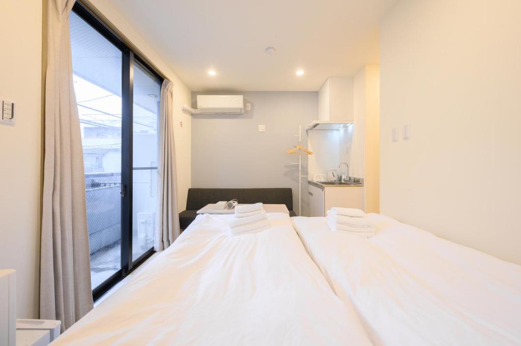 Postel nebo postele na pokoji v ubytování Oku Apartment