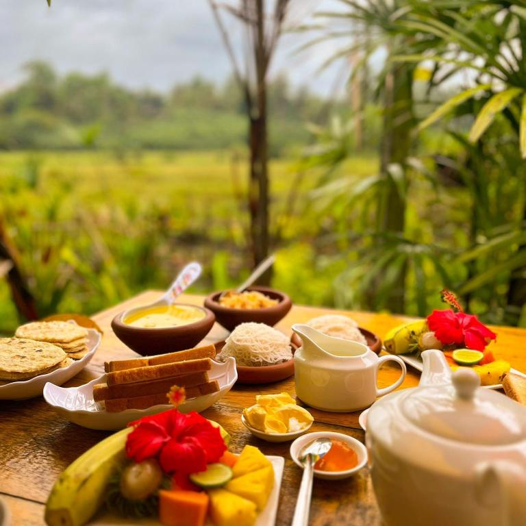 un tavolo apparecchiato con diversi tipi di cibi per la colazione di The WE2 - Wildwood Elegance Escape a Bentota