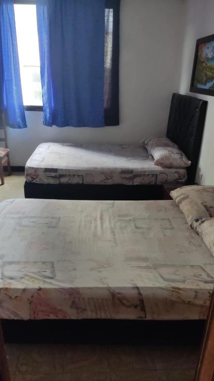 Postel nebo postele na pokoji v ubytování Hotel Eje Cafetero