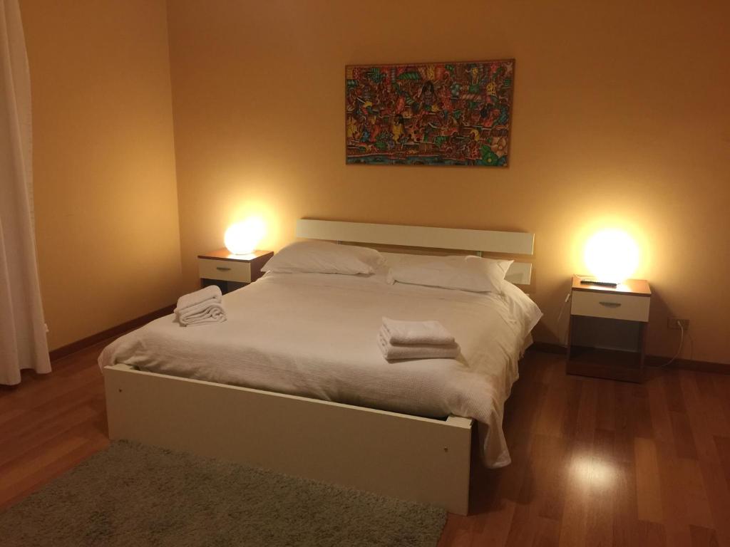 アヴェッツァーノにあるCasina Dei Marsiのベッドルーム1室(ランプ2つ付)