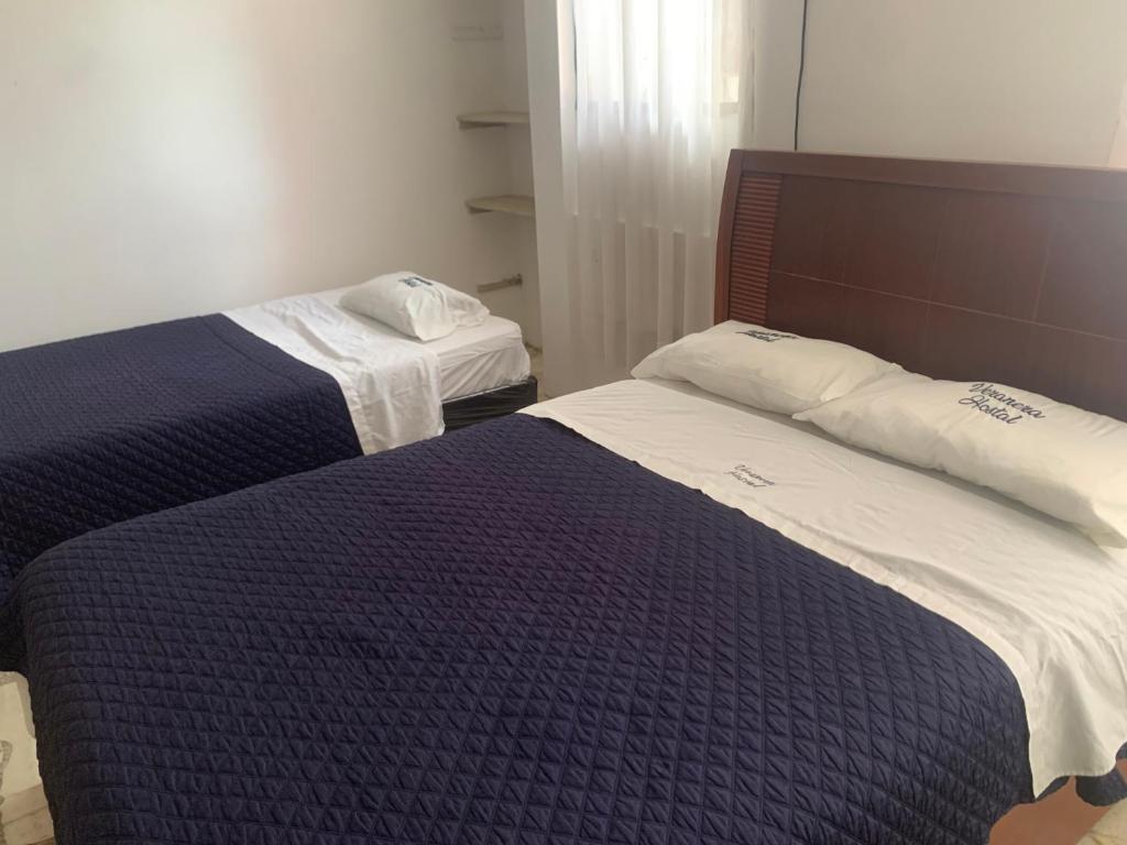 Postel nebo postele na pokoji v ubytování Veranera Hostal