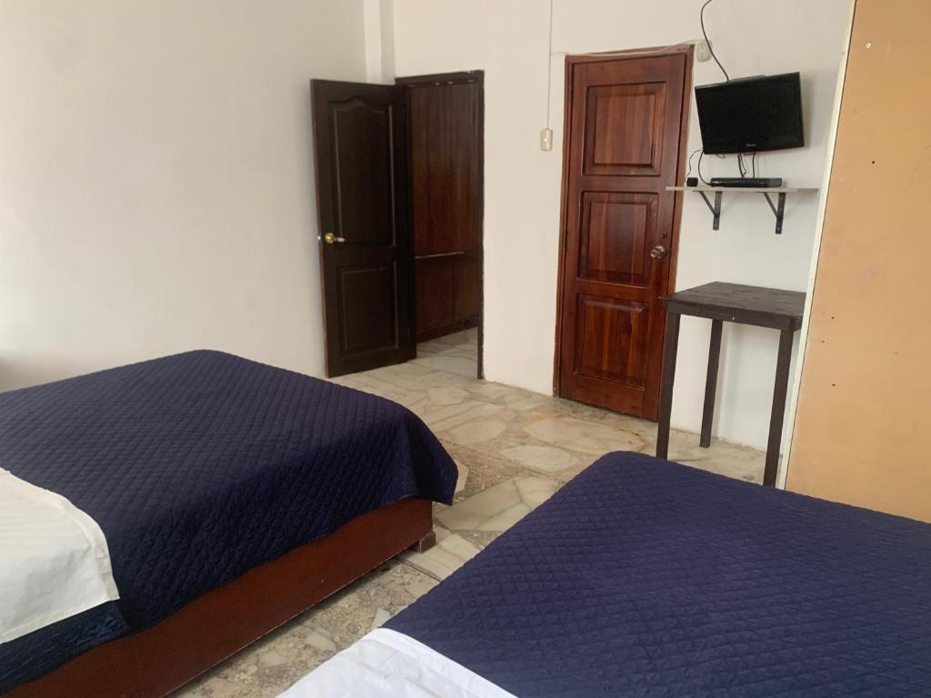 Postel nebo postele na pokoji v ubytování Veranera Hostal