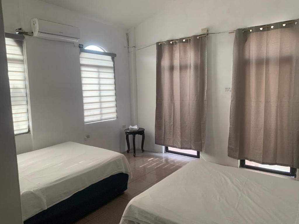 Postel nebo postele na pokoji v ubytování Veranera Hostal