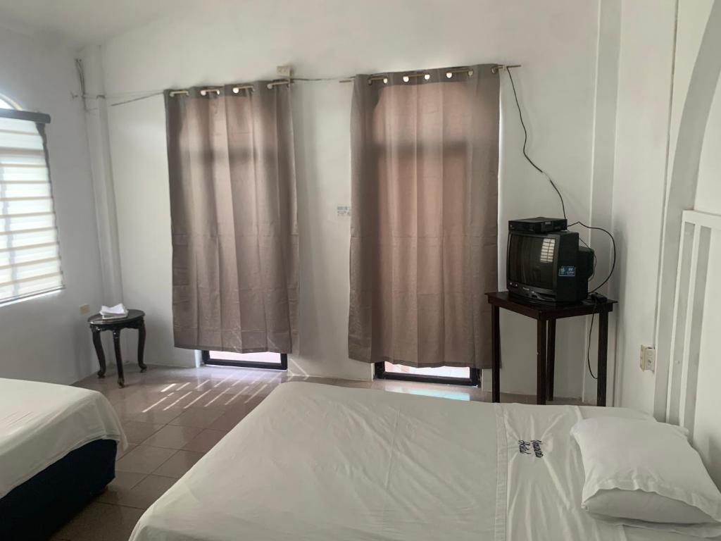 Postel nebo postele na pokoji v ubytování Veranera Hostal