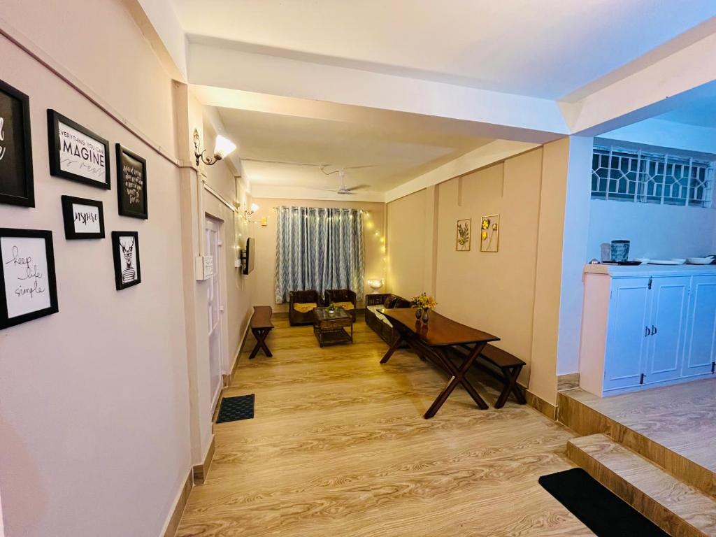 a living room with a table and a couch at Heritage Inn Homestay in Sibsāgar