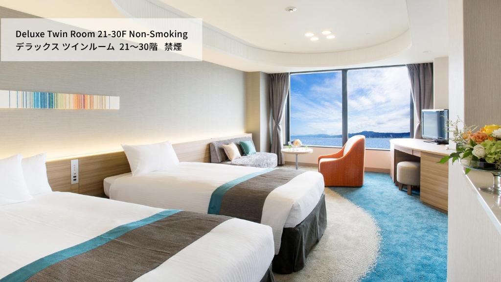 a hotel room with two beds and a television at Lake Biwa Otsu Prince Hotel in Otsu