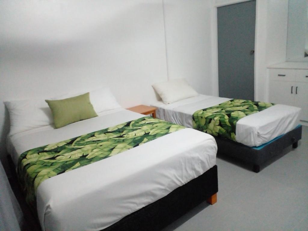 Rúm í herbergi á Yatu Lau Transit Hotel