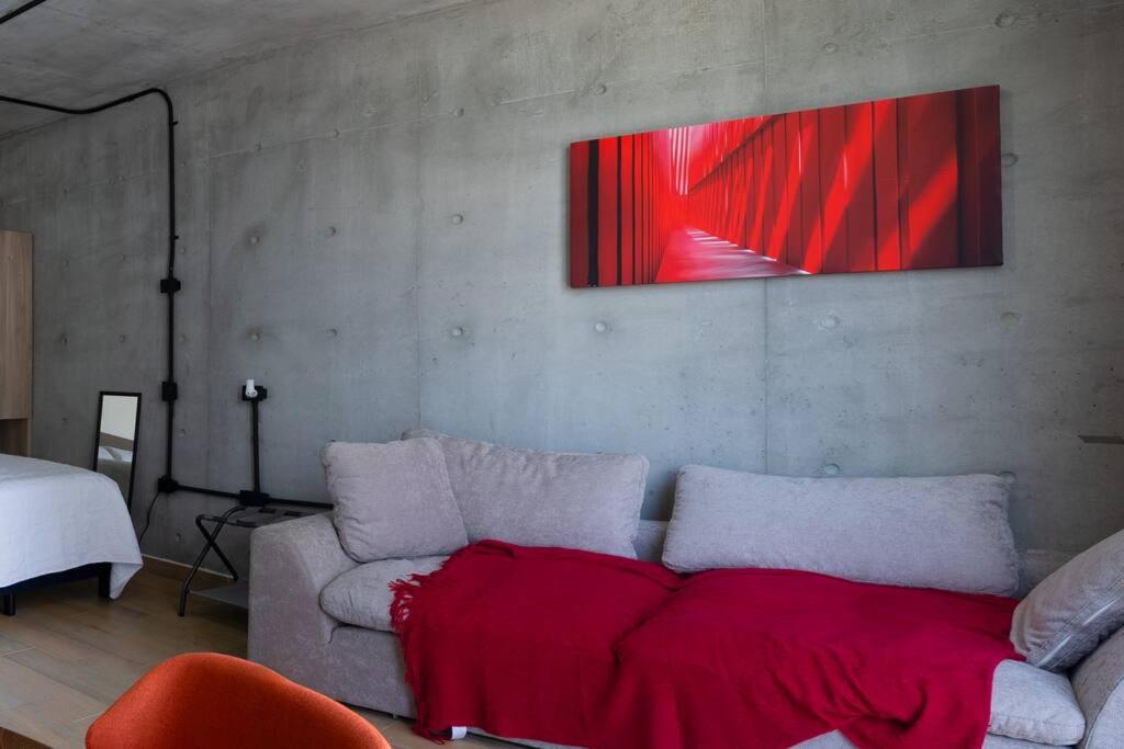 a living room with a couch with a red blanket on it at Prime Monterrey Stay 4 in Monterrey