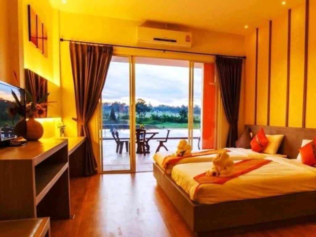 Postel nebo postele na pokoji v ubytování Aurora Resort Khao Yai