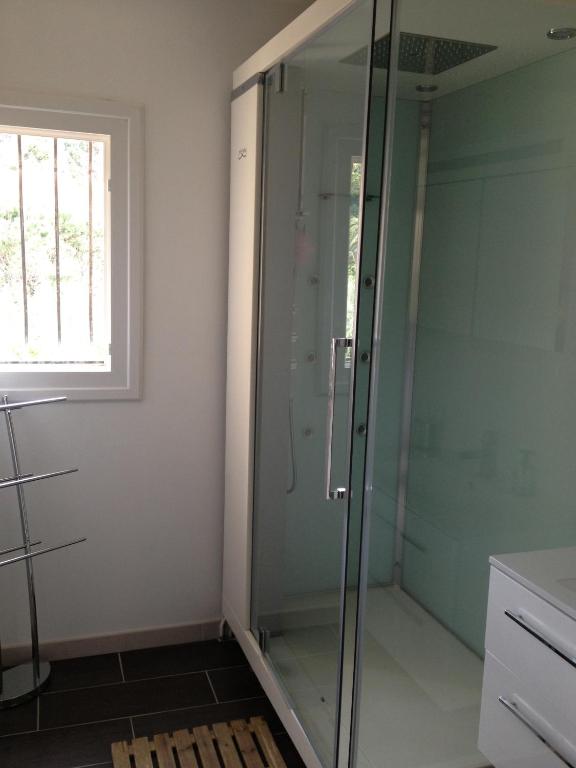 a glass shower in a bathroom with a window at Villa Bougainvilliers in Banyuls-sur-Mer