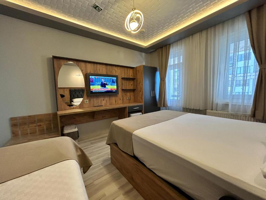 Ένα ή περισσότερα κρεβάτια σε δωμάτιο στο NAHİTA HOTEL