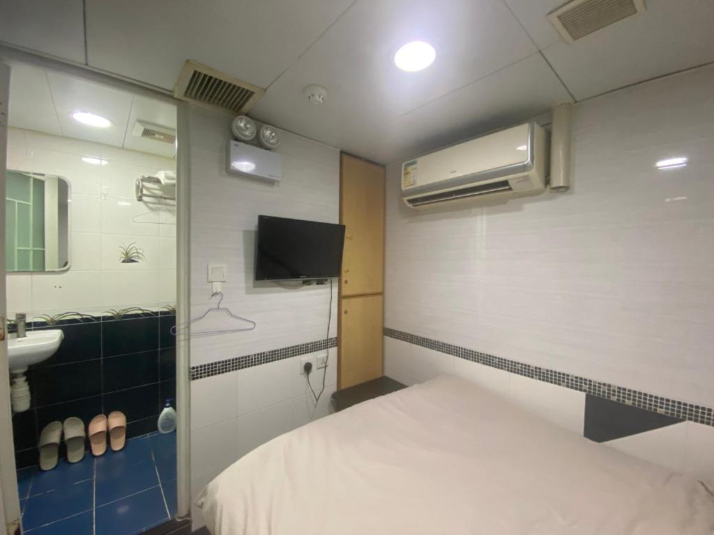 Postel nebo postele na pokoji v ubytování 香港百乐宾馆 Best Guesthouse