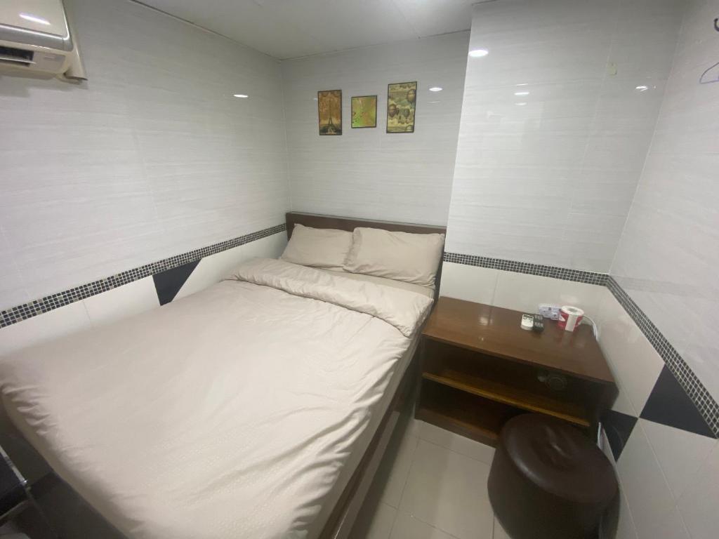 Postel nebo postele na pokoji v ubytování 香港百乐宾馆 Best Guesthouse