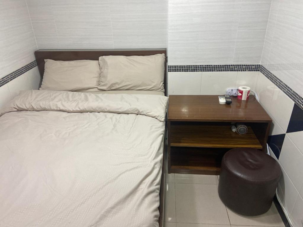 Postel nebo postele na pokoji v ubytování 香港百乐宾馆 Best Guesthouse