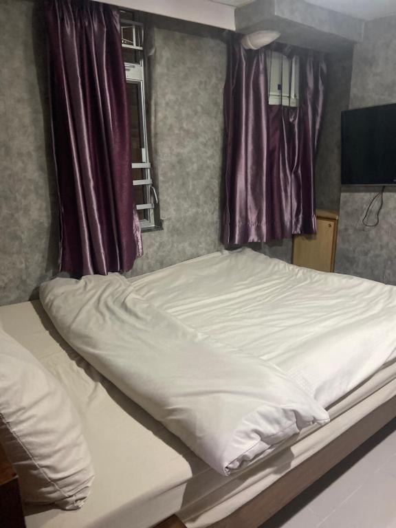 Postel nebo postele na pokoji v ubytování 香港百乐宾馆 Best Guesthouse