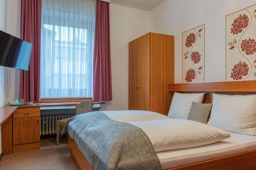 Postel nebo postele na pokoji v ubytování Centro Hotel Sautter Stuttgart City, Trademark Collection by Wyndham