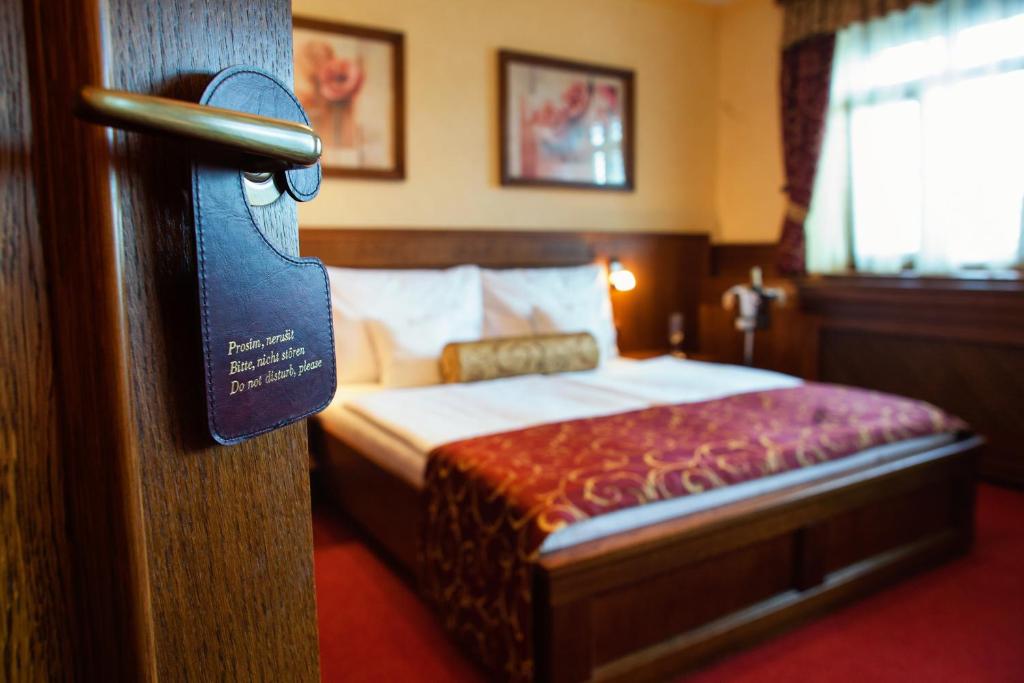Postel nebo postele na pokoji v ubytování Hotel Abácie & Wellness