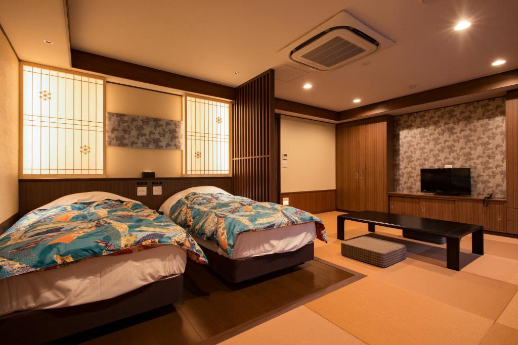 Postel nebo postele na pokoji v ubytování Yuzawa Grand Hotel