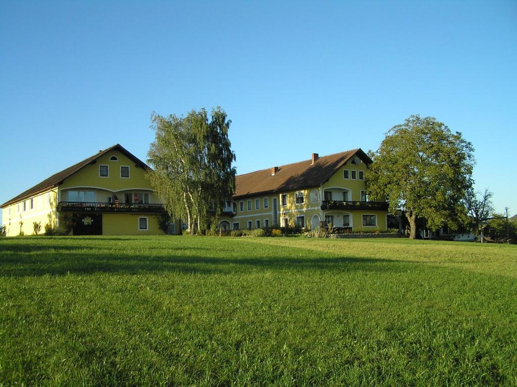 a large house on a field of green grass at Windhör in Saxen