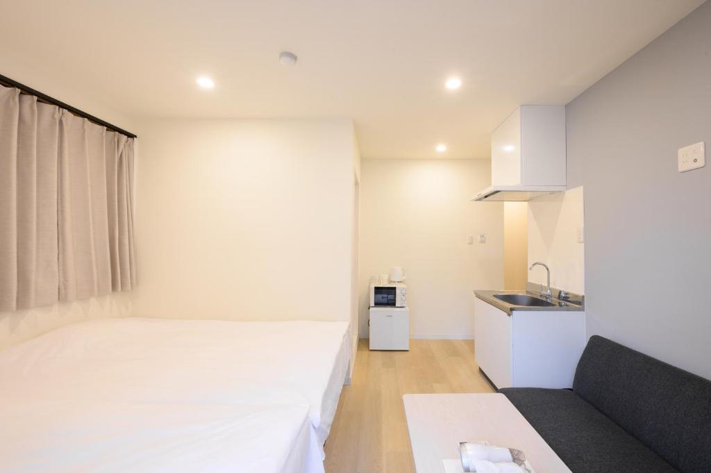 Postel nebo postele na pokoji v ubytování Oku Apartment