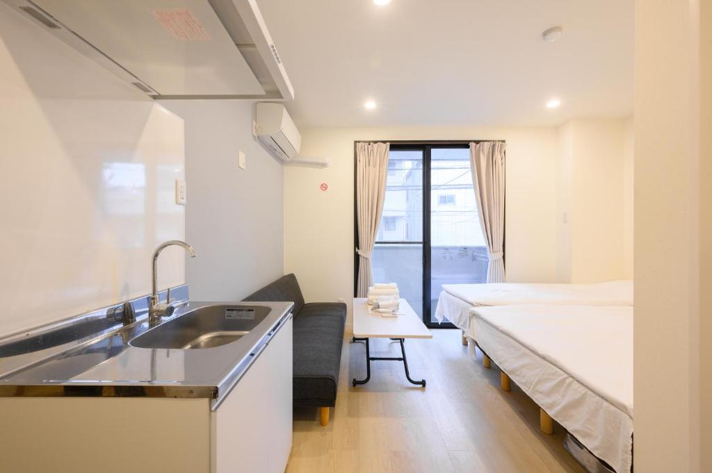 Postel nebo postele na pokoji v ubytování Oku Apartment