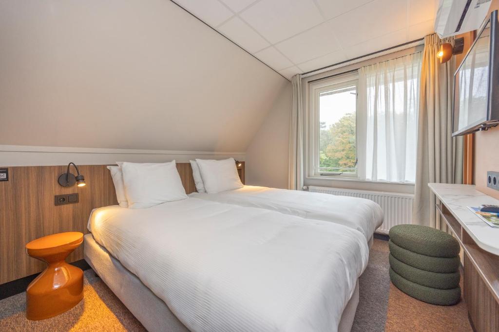 Postel nebo postele na pokoji v ubytování Fletcher Boutique Hotel De Mallejan