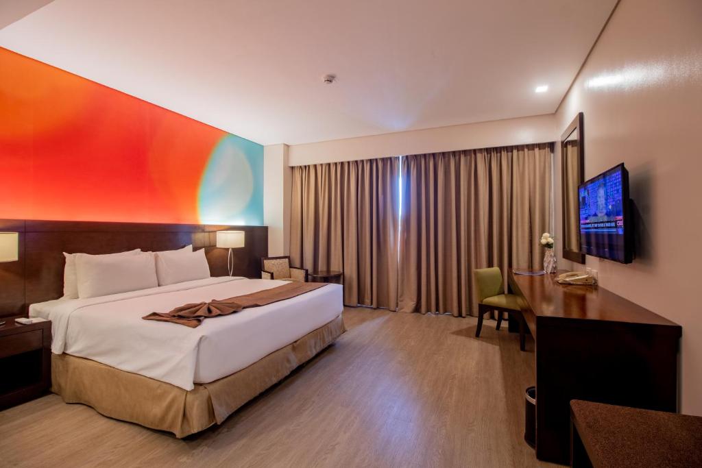 Postel nebo postele na pokoji v ubytování Harolds Hotel Cebu