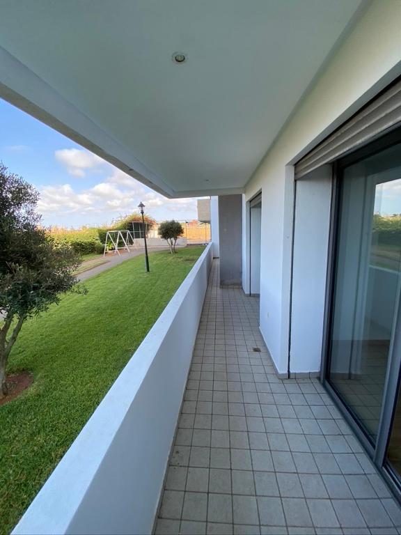 a balcony of a house with a view of a yard at Mansoria in Mohammedia
