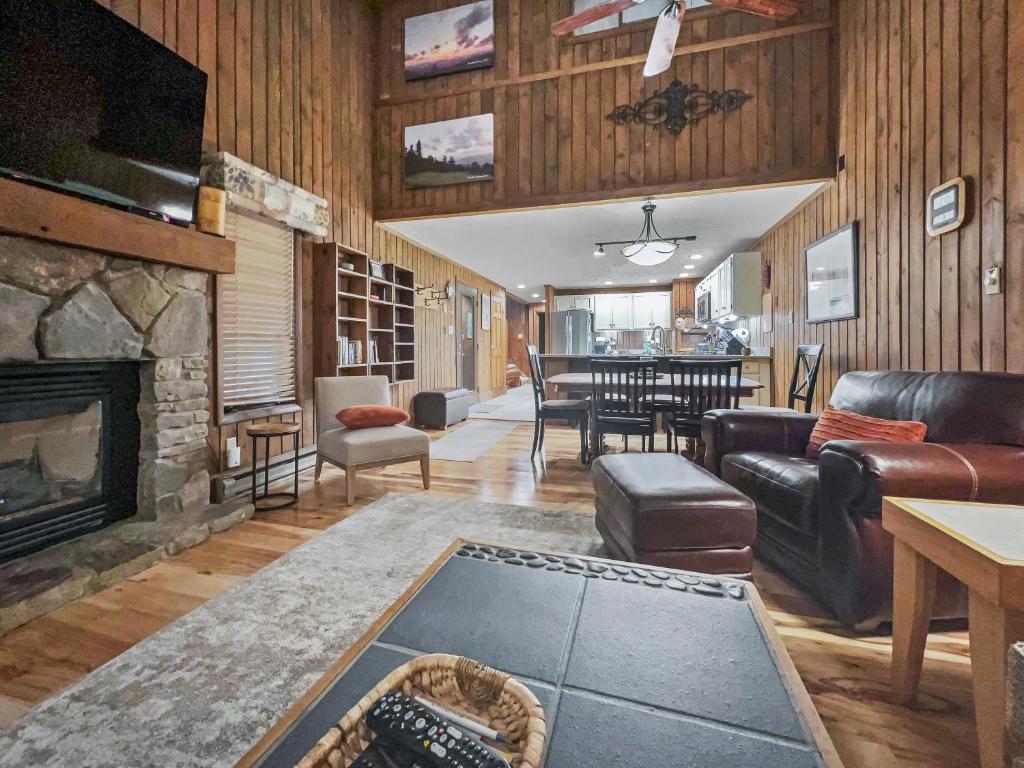 a living room with a couch and a fireplace at Wabasso 8 Cozy Snowshoe Retreat Covered EZ Parking WiFi Deck in Snowshoe