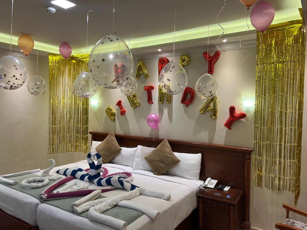 Postel nebo postele na pokoji v ubytování Amwaj Hotel