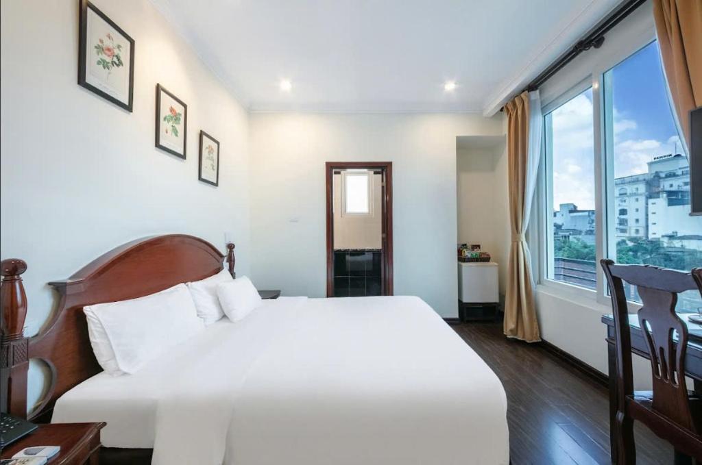Postel nebo postele na pokoji v ubytování A25 Hotel - 15 Trần Quốc Toản