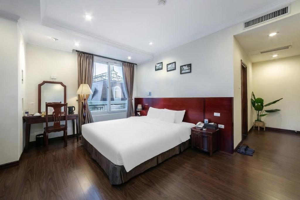 Postel nebo postele na pokoji v ubytování A25 Hotel - 15 Trần Quốc Toản