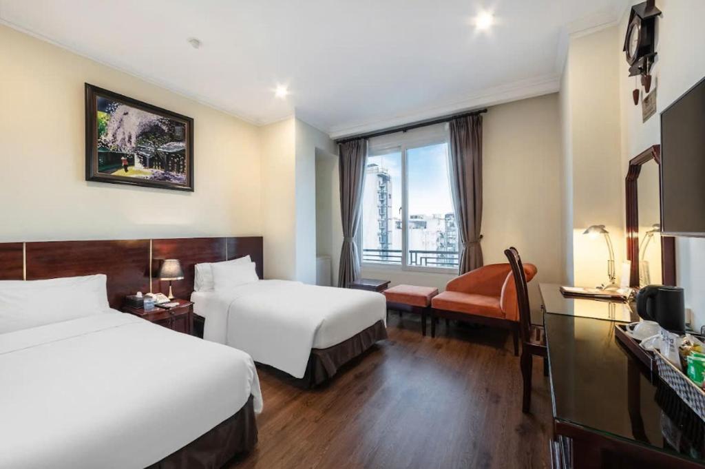 Postel nebo postele na pokoji v ubytování A25 Hotel - 15 Trần Quốc Toản