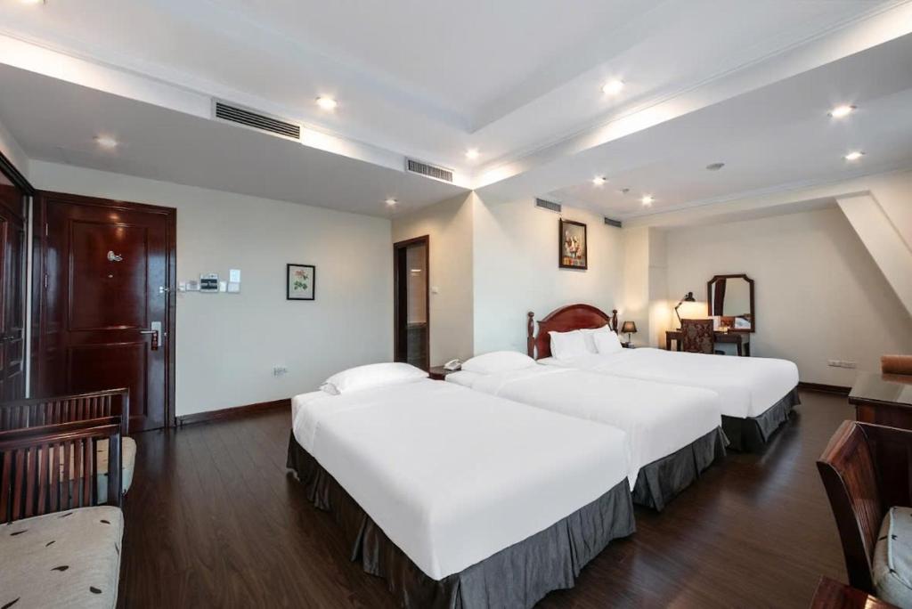 Postel nebo postele na pokoji v ubytování A25 Hotel - 15 Trần Quốc Toản
