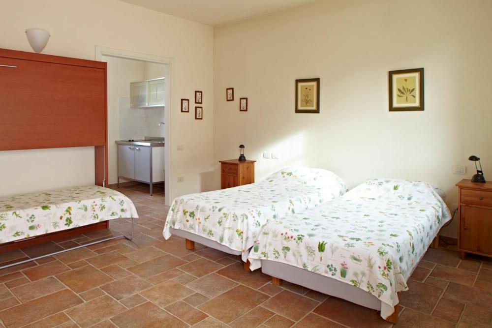 Postel nebo postele na pokoji v ubytování Agriturismo Vignarello