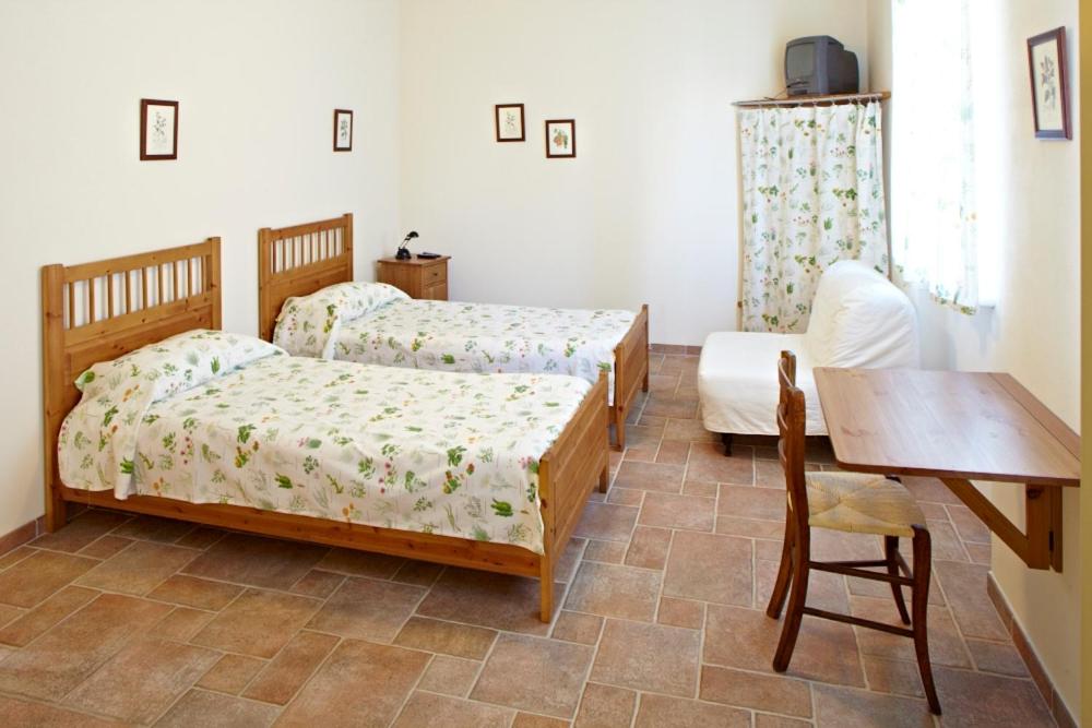 Postel nebo postele na pokoji v ubytování Agriturismo Vignarello