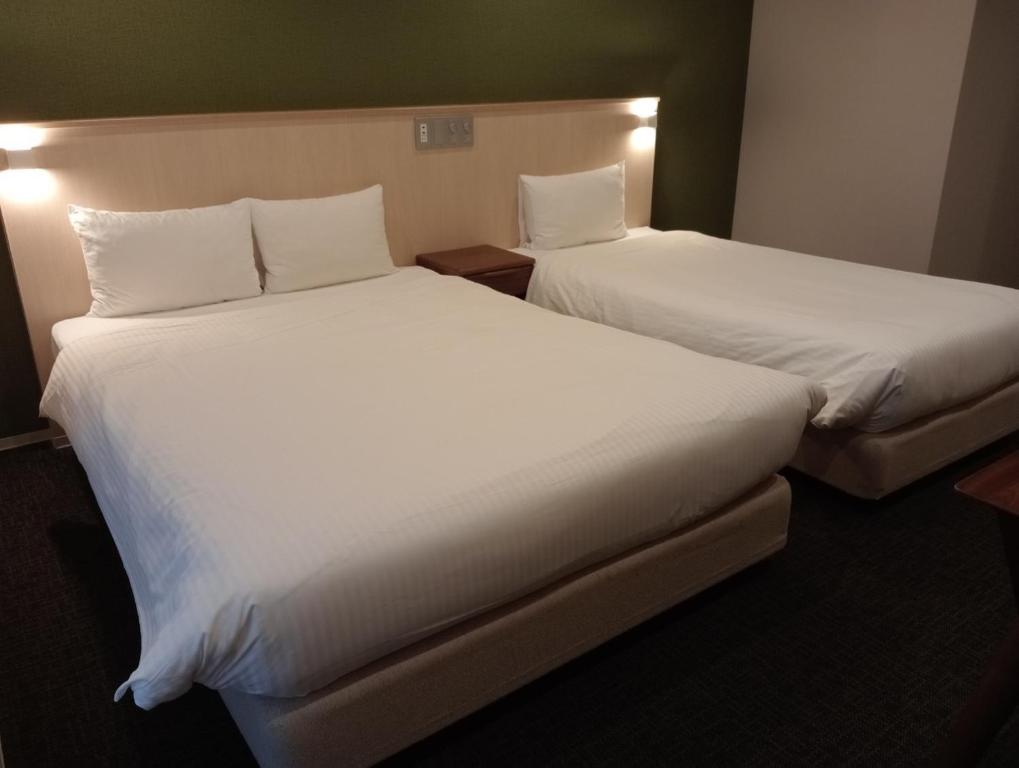 Postel nebo postele na pokoji v ubytování HIZ HOTEL Gion-Shirakawa