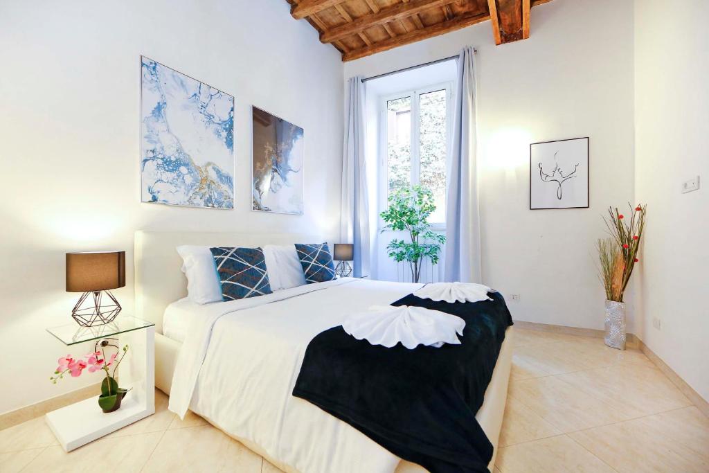 a bedroom with a large bed and a window at Mario Suite Spagna in Rome