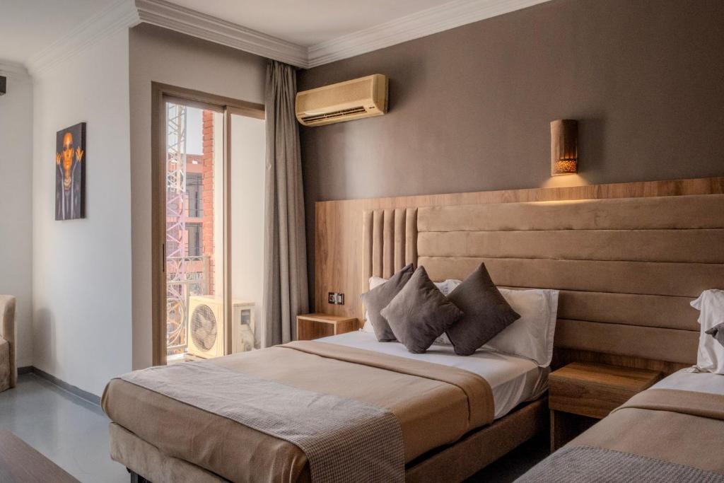 Postel nebo postele na pokoji v ubytování Imperial Holiday Hôtel & spa